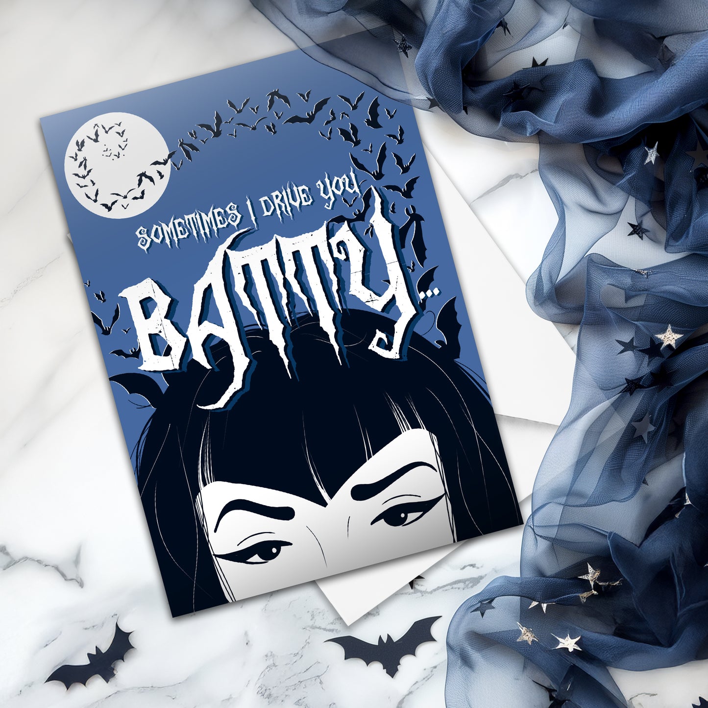 A large glossy A5 greeting card designed in a vintage horror poster style. The cover features a tired mum with bats flying over her head and the phrase "Sometimes I drive you batty...". Inside reads "But I’m your favourite vampire brat", with UK or US spelling options. Comes with a white envelope.