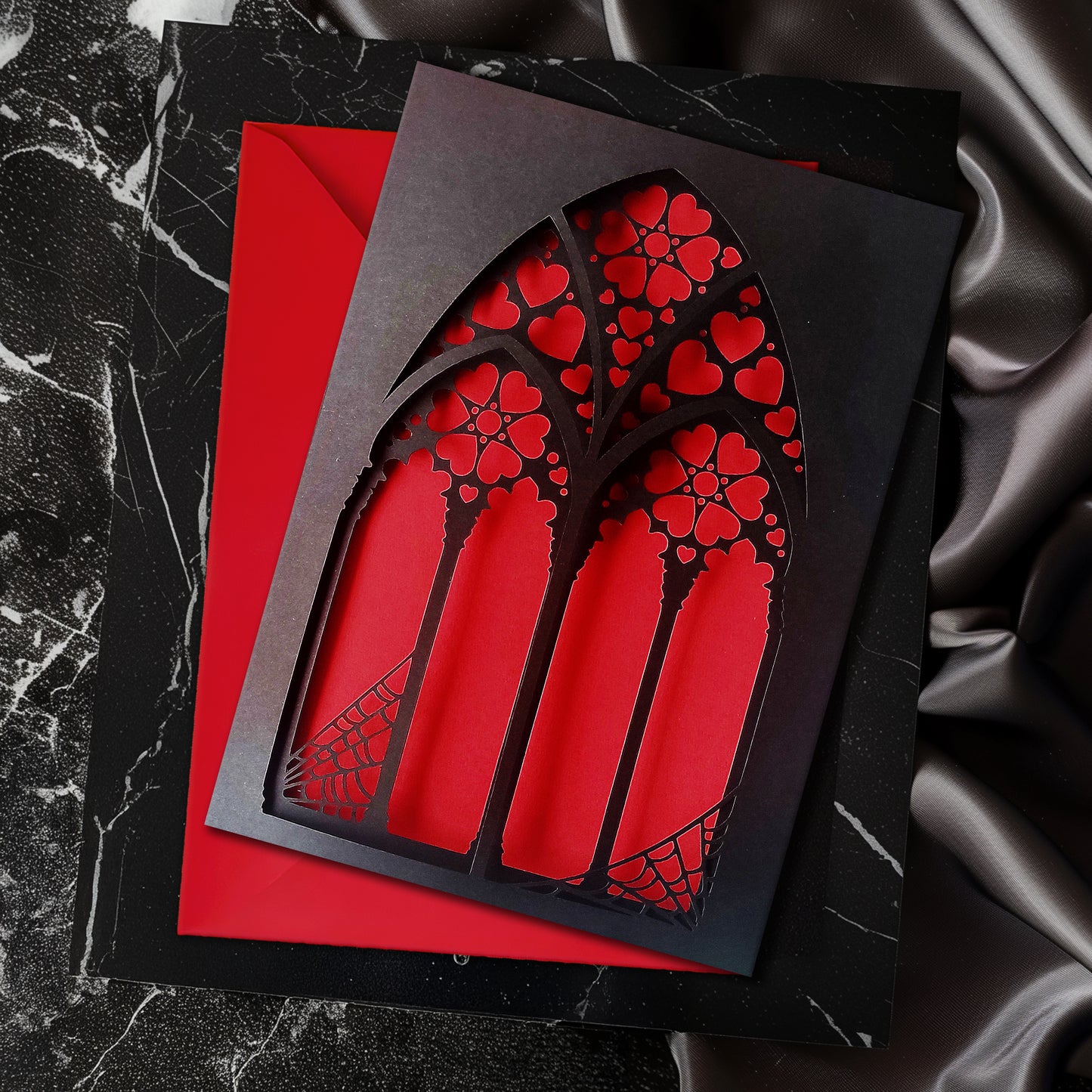 Handmade A5 black greeting card with layered gothic arch design and red heart cut-out revealing soft pink interior. Blank inside with envelope included. Perfect for gothic weddings, anniversaries, or alternative Valentine’s Day.
