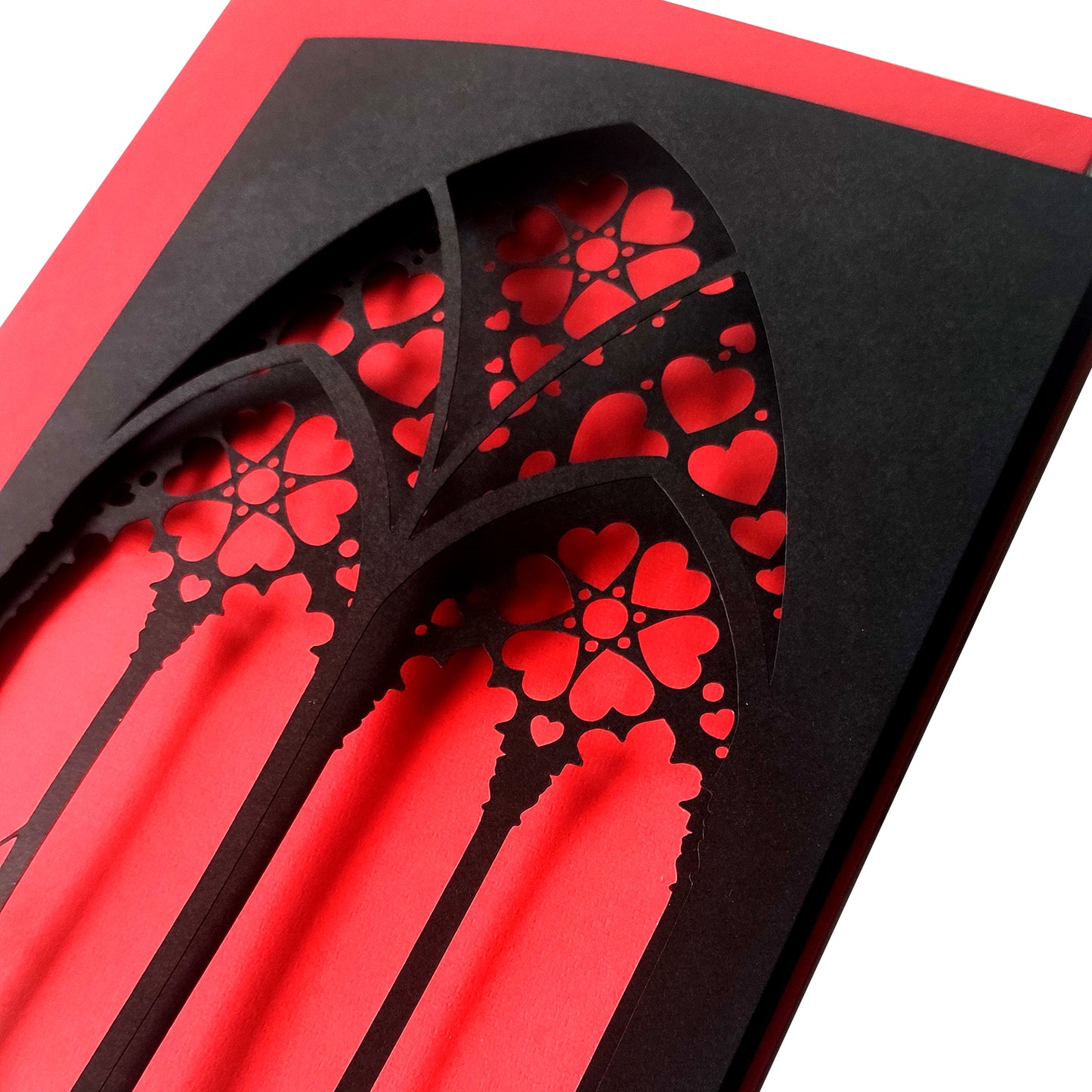 Handmade A5 black greeting card with layered gothic arch design and red heart cut-out revealing soft pink interior. Blank inside with envelope included. Perfect for gothic weddings, anniversaries, or alternative Valentine’s Day.