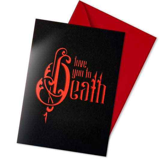 Handmade A5 gothic romance card with “Love You to Death” cut from black outer layer, revealing a deep red interior. Includes envelope and blank inside for your own message. Perfect for weddings, anniversaries, or spooky Valentine’s Day gifting.