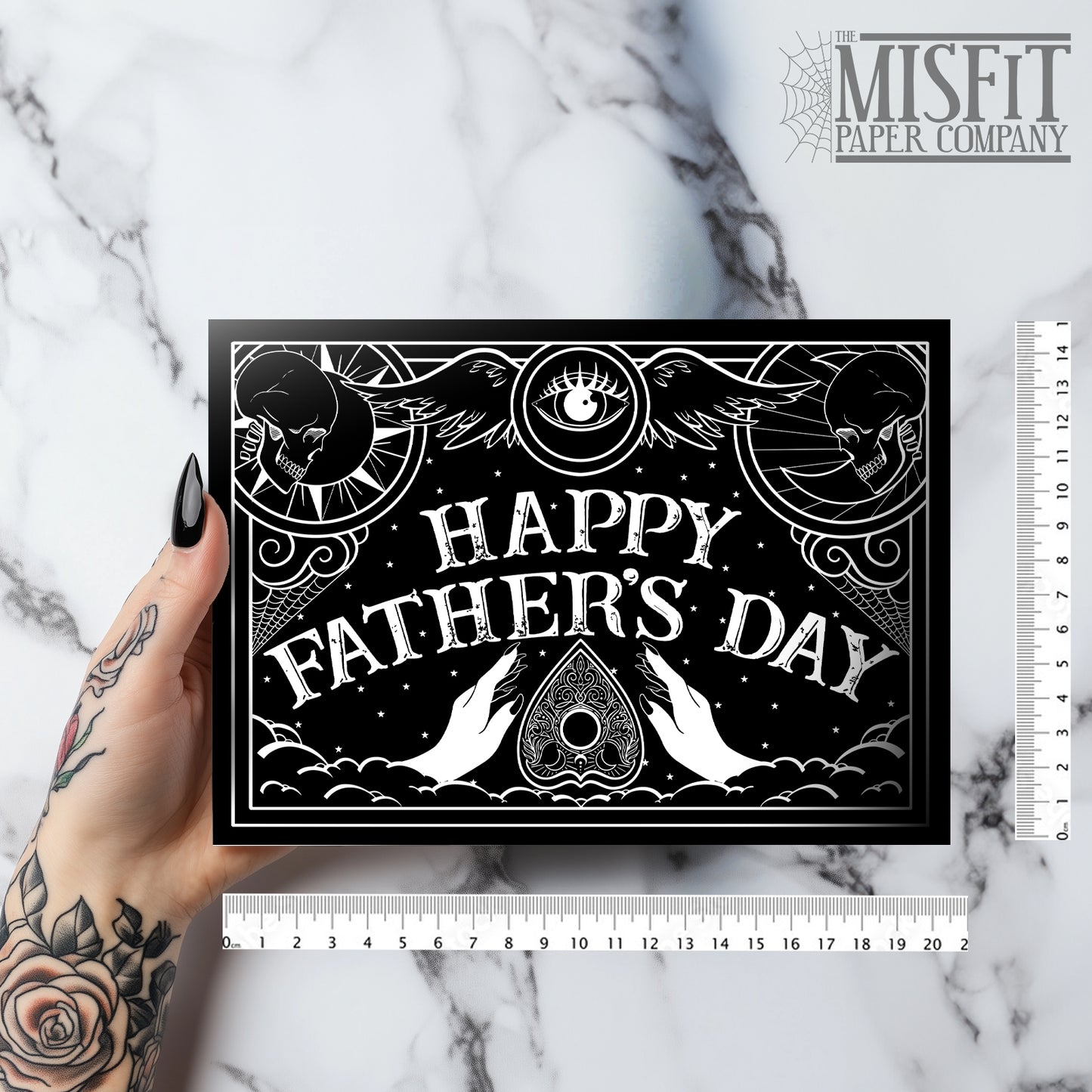 A5 gothic Father’s Day card featuring black and white Ouija board design with ornate “Happy Father’s Day” lettering and planchette detail. Blank inside with envelope. Ideal for witchy, spooky, or alternative dads.
