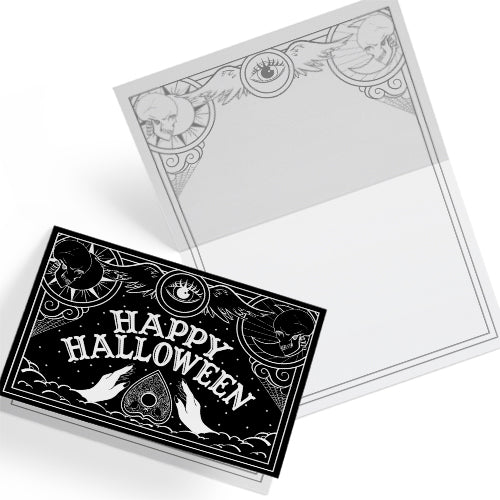 A black glossy A5 Halloween card with a white Ouija board-inspired “Happy Halloween” design, styled with gothic props on a dark background.