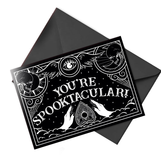 Gothic greeting card with black and white Ouija board design and spooky lettering that reads “Have a Spooktacular Day,” perfect for any eerie occasion.