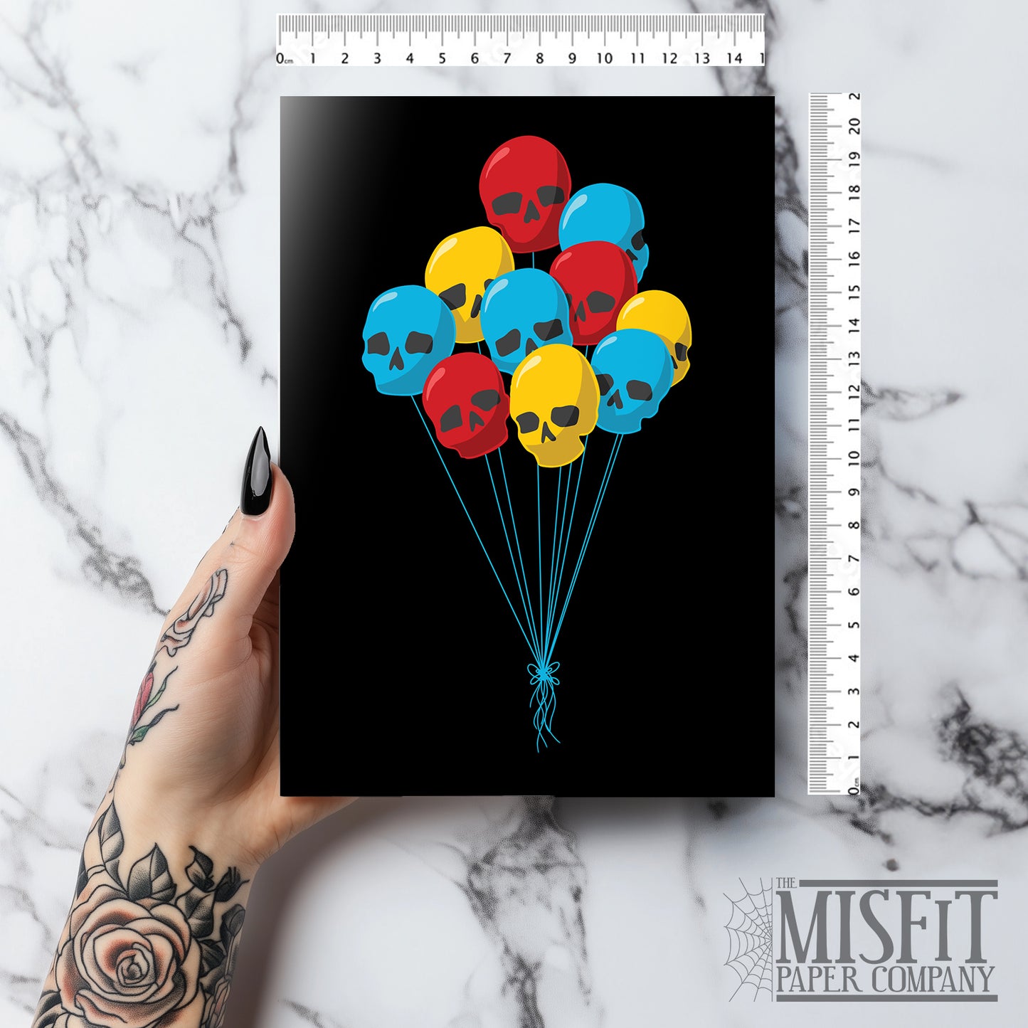 Black birthday card featuring a bunch of colourful skull-shaped balloon with blue string, perfect for alternative and spooky celebrations.