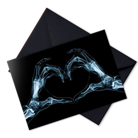 Large A5 gothic greeting card with a skeleton X-ray image of two hands forming a heart on a glossy black background. Blank inside, with envelope included. Ideal for alternative Valentine’s Day, anniversaries, or dark romance gestures.