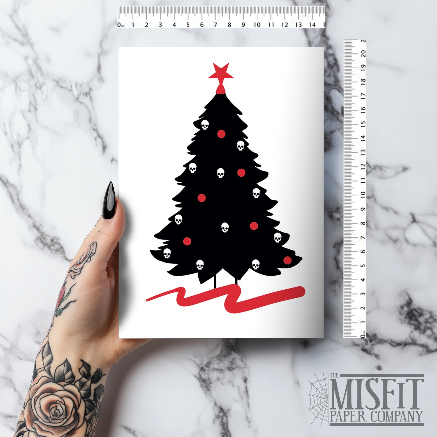 A5 glossy portrait Christmas card on white with black tree silhouette decorated with small skull baubles and a red pentacle star topper, red sweep at base. Includes red envelope. Blank inside.