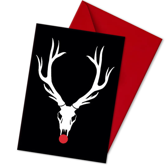 A5 glossy portrait Christmas card with white reindeer skull and large antlers on black background, bright red circle for Rudolph's nose. Minimal graphic style. Includes red envelope. Blank inside.