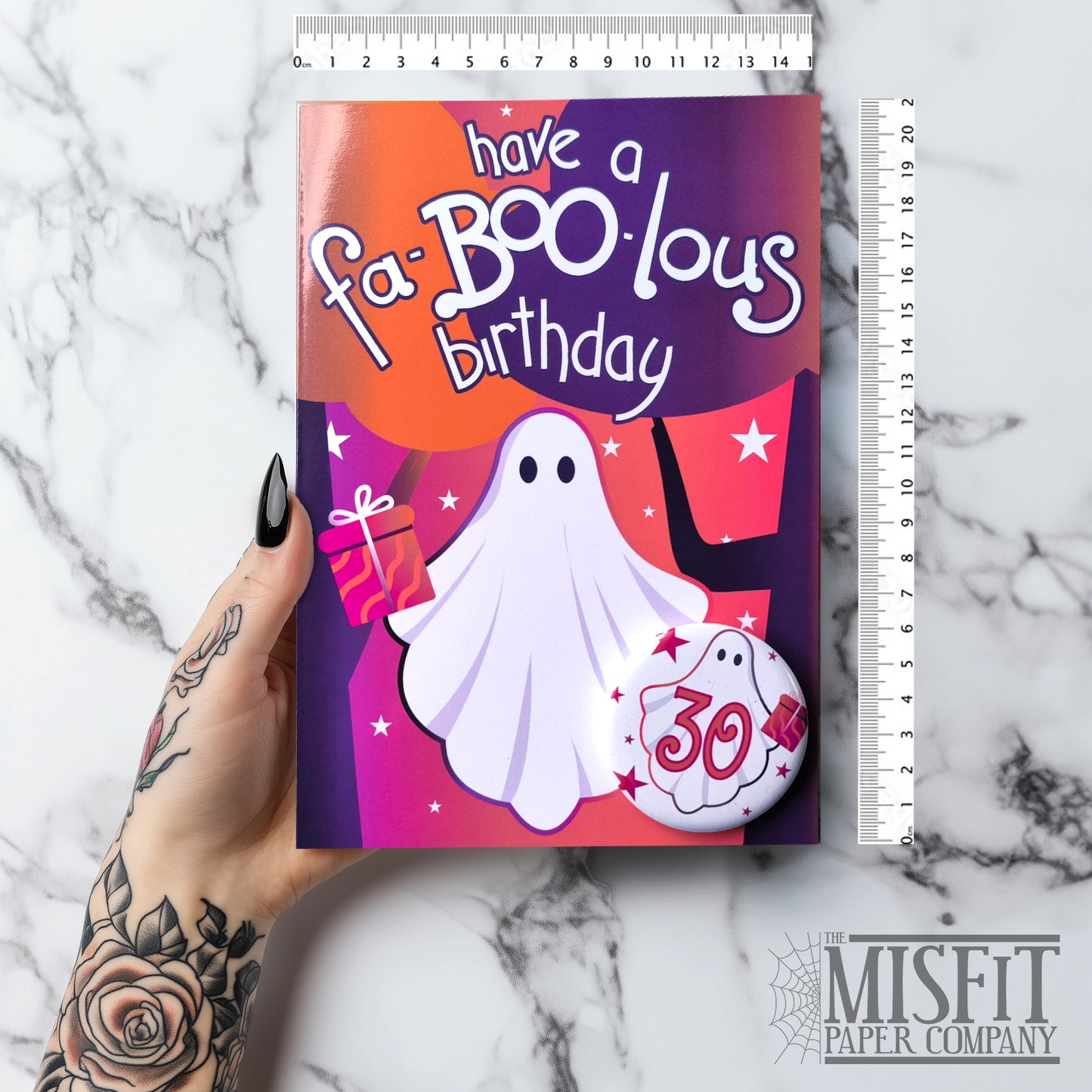 Large glossy A5 birthday card with spooky ghost characters and bold lettering that reads “Have a Fa-BOO-lous Birthday.” A 58mm badge with a custom age is attached to the front. Blank inside with envelope included. Perfect for gothic, alternative, and Halloween-loving birthday celebrators.