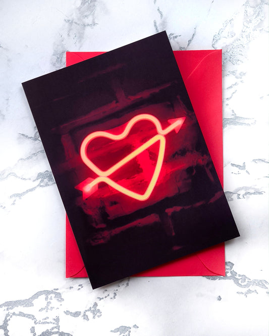 A5 Valentine card with a red neon heart graphic glowing on a black background. Minimal gothic style. Portrait format, blank inside, includes envelope.
