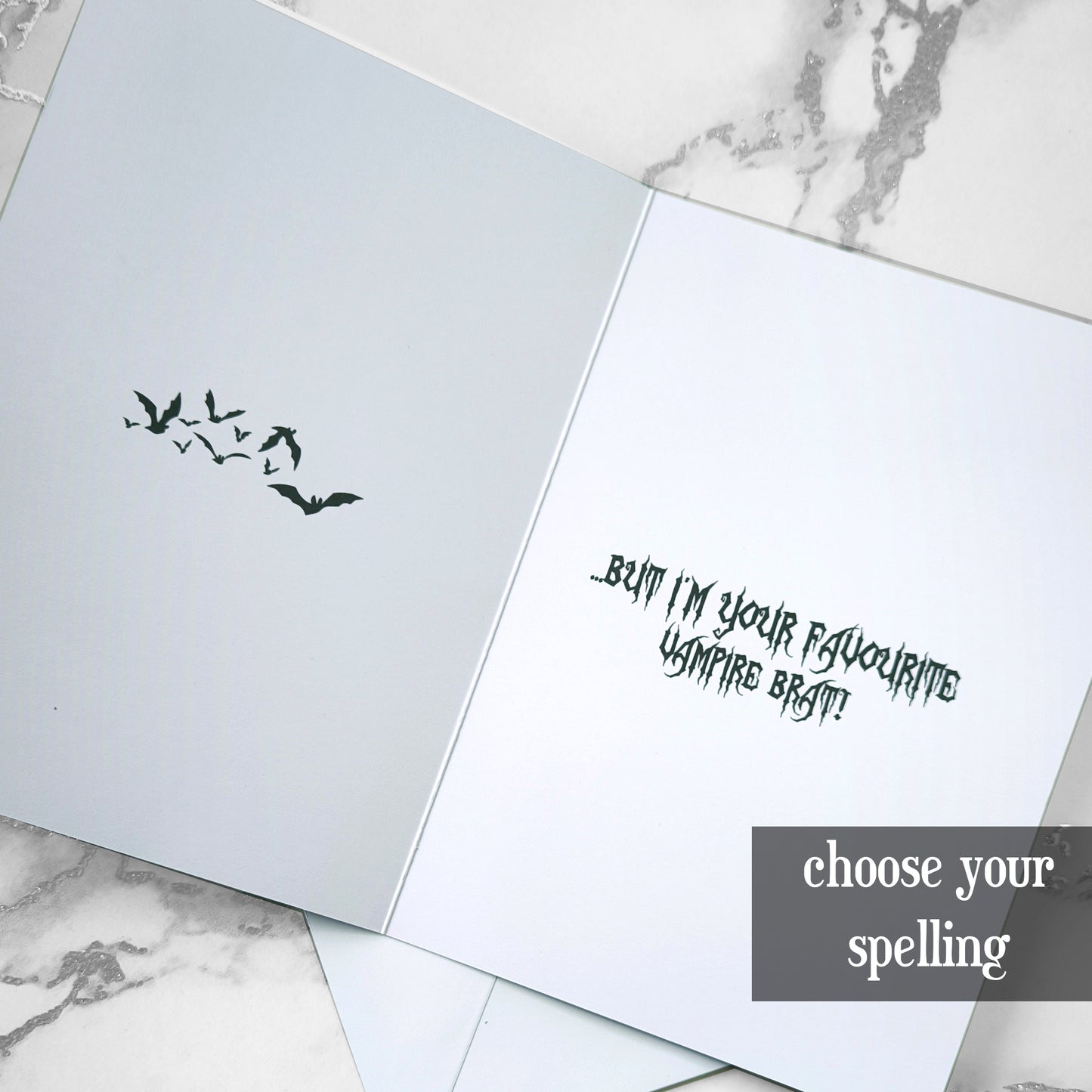 A large glossy A5 greeting card designed in a vintage horror poster style. The cover features a tired mum with bats flying over her head and the phrase "Sometimes I drive you batty...". Inside reads "But I’m your favourite vampire brat", with UK or US spelling options. Comes with a white envelope.
