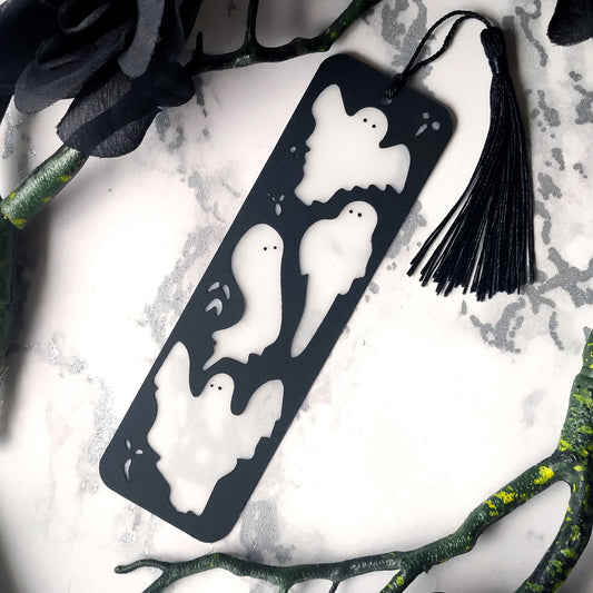 Spooky black bookmark with inlaid translucent white ghosts, and matching silky tassel. Handmade gift for book readers.