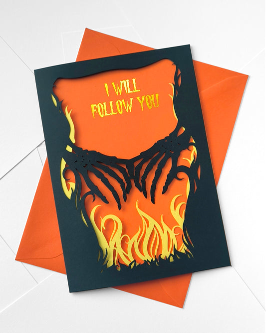 A5 gothic layered papercut greeting card. The outer black layer features skeleton hands reaching across an inner layer of yellow flames. the orange background reads "i will follow you" in gold foil. Inside is blank for your own personalised message, making it versatile for anniversaries, valentines and more.