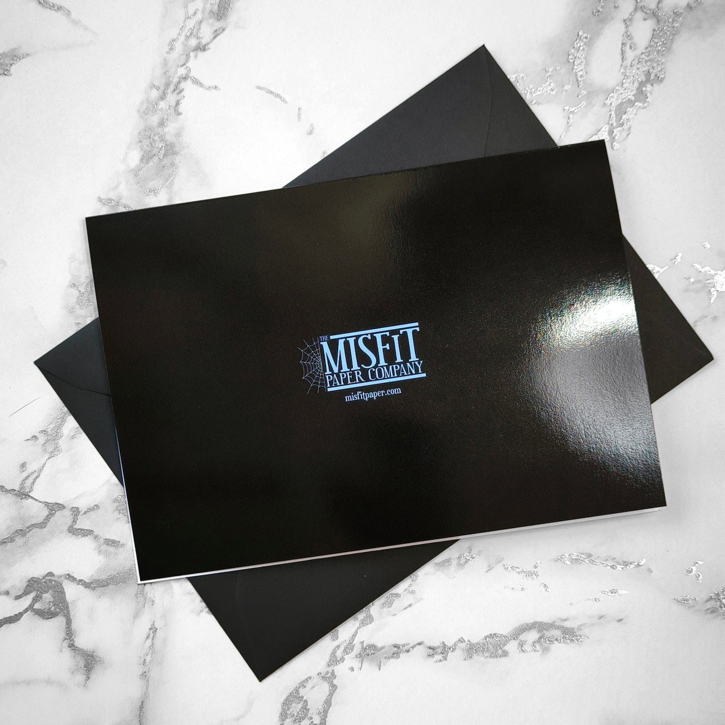 Large A5 gothic greeting card with a skeleton X-ray image of two hands forming a heart on a glossy black background. Blank inside, with envelope included. Ideal for alternative Valentine’s Day, anniversaries, or dark romance gestures.