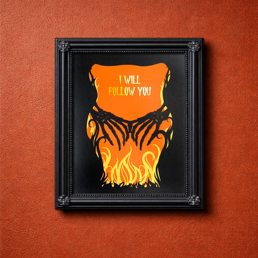 Layered papercut artwork of two skeleton hands reaching through yellow flames over an orange background, with the words I Will Follow You in gold foil lettering. 8 x 10 inches. frame not included.