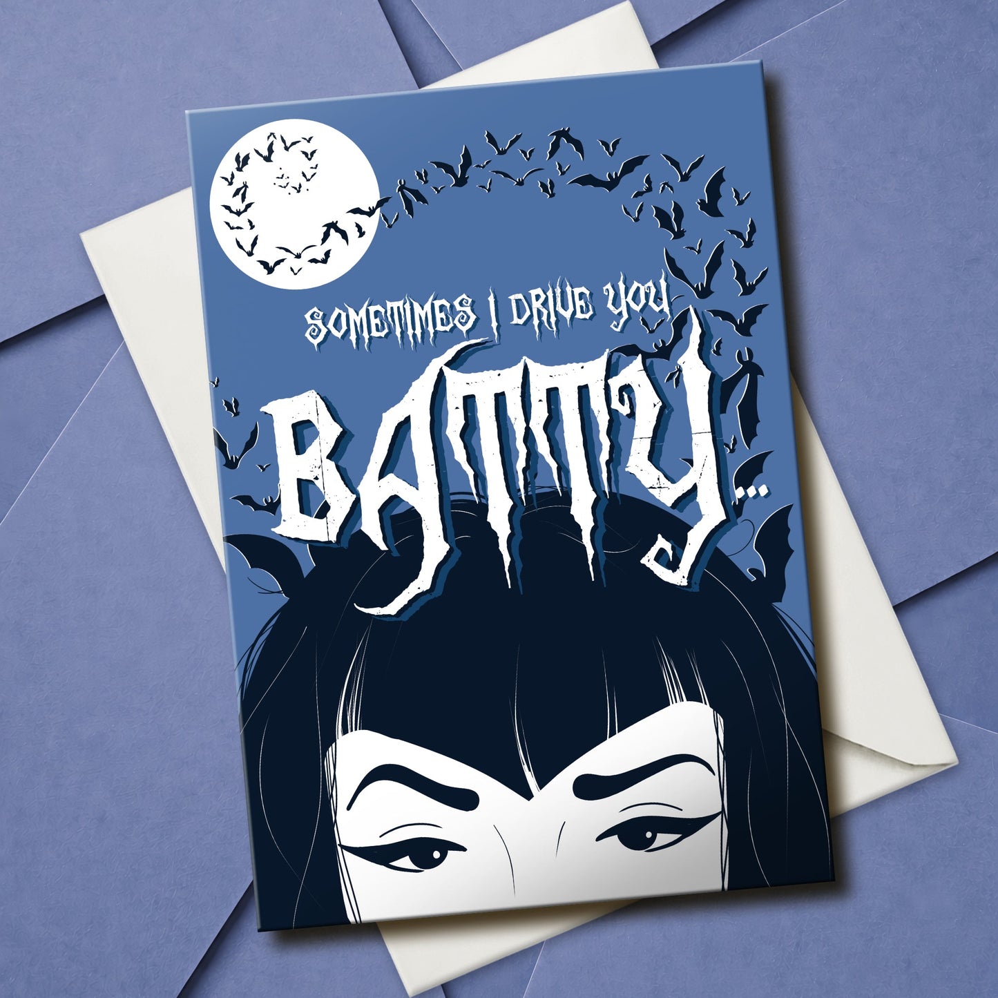 A large glossy A5 greeting card designed in a vintage horror poster style. The cover features a tired mum with bats flying over her head and the phrase "Sometimes I drive you batty...". Inside reads "But I’m your favourite vampire brat", with UK or US spelling options. Comes with a white envelope.