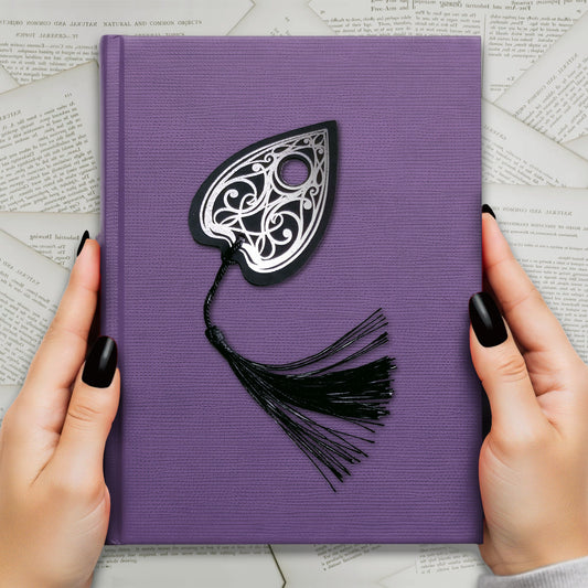 Handmade Gothic Ouija planchette bookmark with intricate silver metallic detailing and a black tassel, perfect for witchy, spooky, and alternative book lovers.