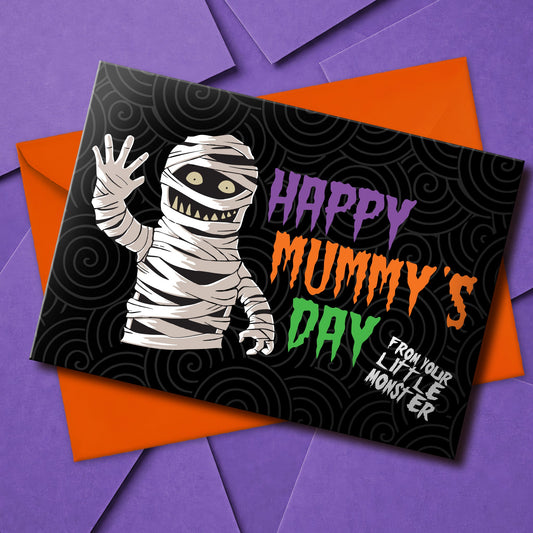 A large landscape A5 greeting card featuring a spooky cute mummy illustration with the phrase "Happy Mummy’s Day" in bold Halloween colours. The inside is decorated with a spiral motif but has no text. Comes with a bright orange envelope.