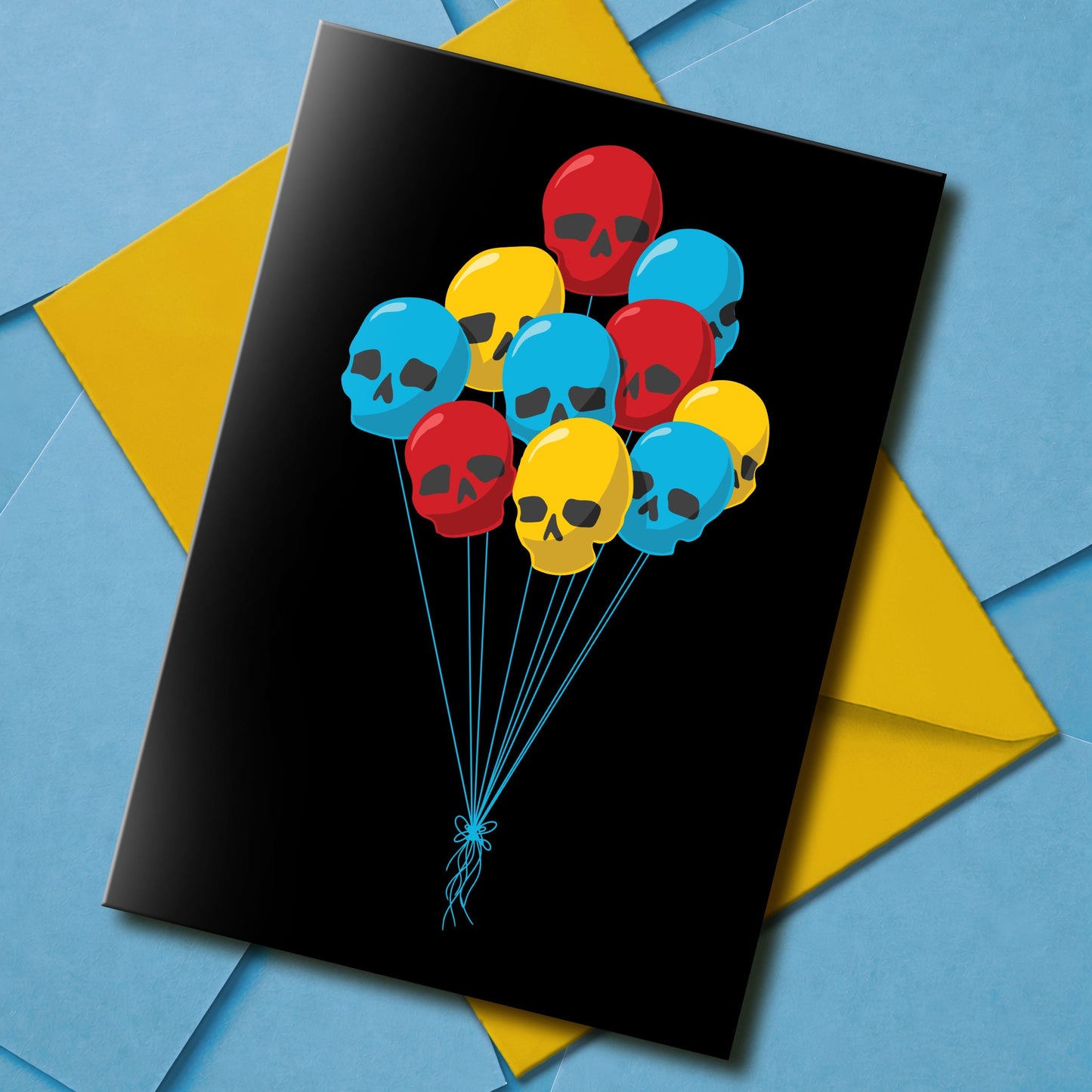 Black birthday card featuring a bunch of colourful skull-shaped balloon with blue string, perfect for alternative and spooky celebrations.
