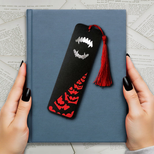 Gothic Dracula bookmark with silver metallic fangs and a flock of black foil bats flying across a deep red background. Finished with a matching tassel. Perfect for fans of vampires, classic horror, and dark, alternative literature.