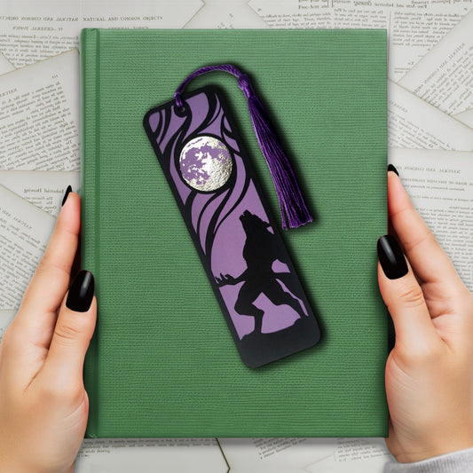 Classic horror werewolf bookmark featuring a black werewolf silhouette against a purple background and metalllic silver full moon, with matching tassel, perfect for gothic readers.
