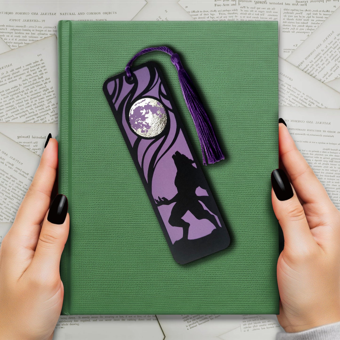 Classic horror werewolf bookmark featuring a black werewolf silhouette against a purple background and metalllic silver full moon, with matching tassel, perfect for gothic readers.