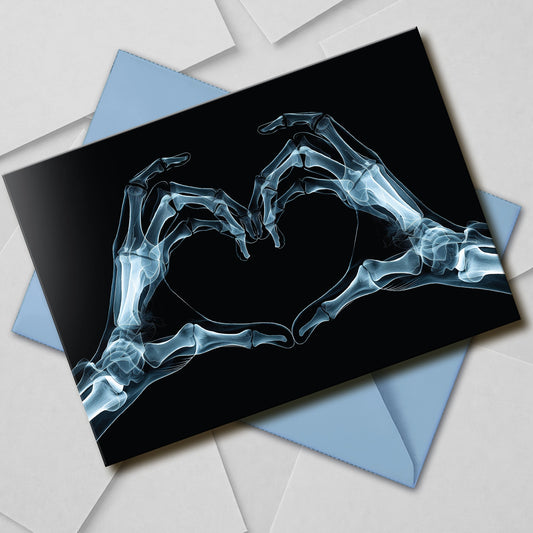 Large A5 gothic greeting card with a skeleton X-ray image of two hands forming a heart on a glossy black background. Blank inside, with envelope included. Ideal for alternative Valentine’s Day, anniversaries, or dark romance gestures.