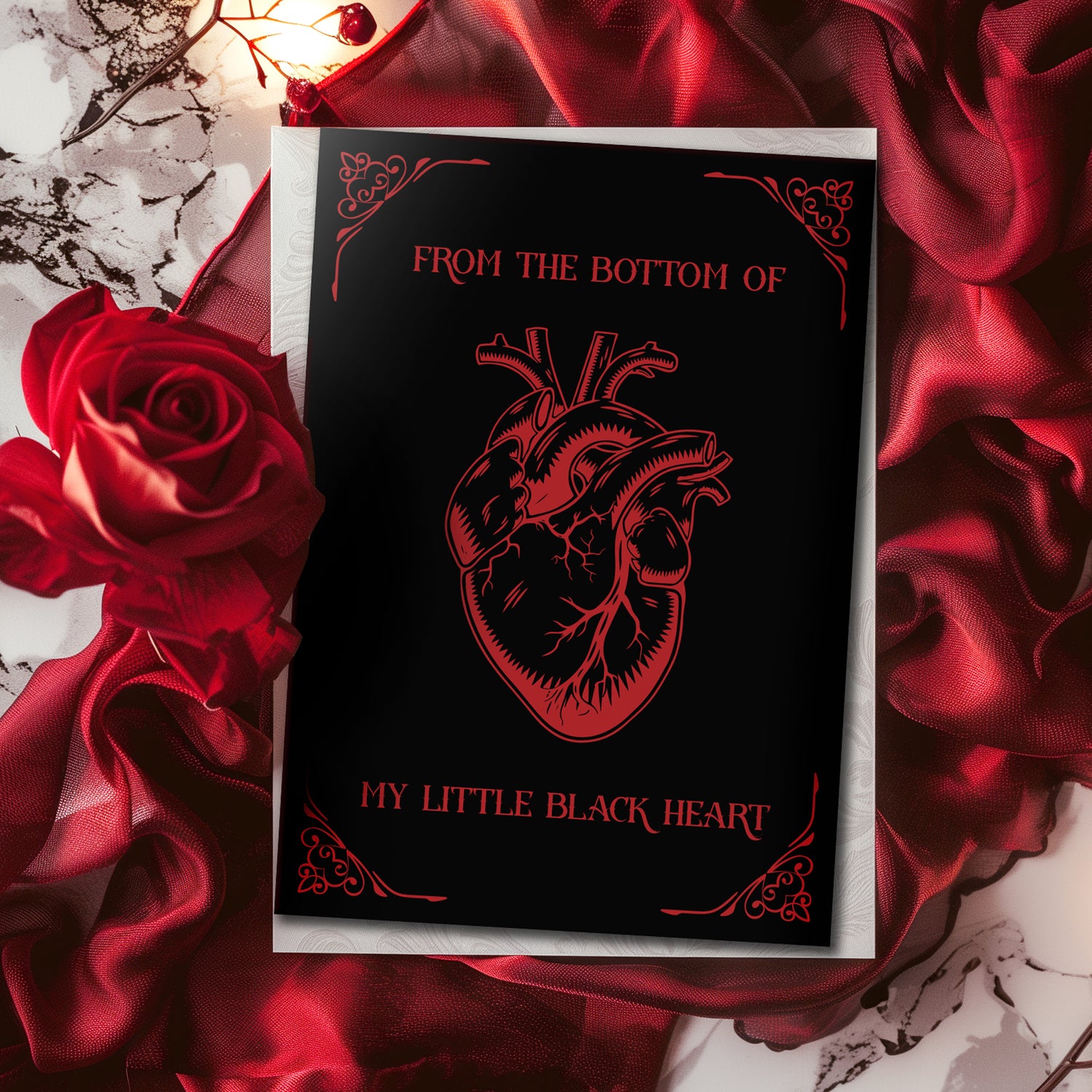 Glossy black A5 card with a lifelike red Victorian heart illustration. Text says “From the Bottom of My Little Black Heart.” Includes envelope. Perfect for goth and alternative romance.