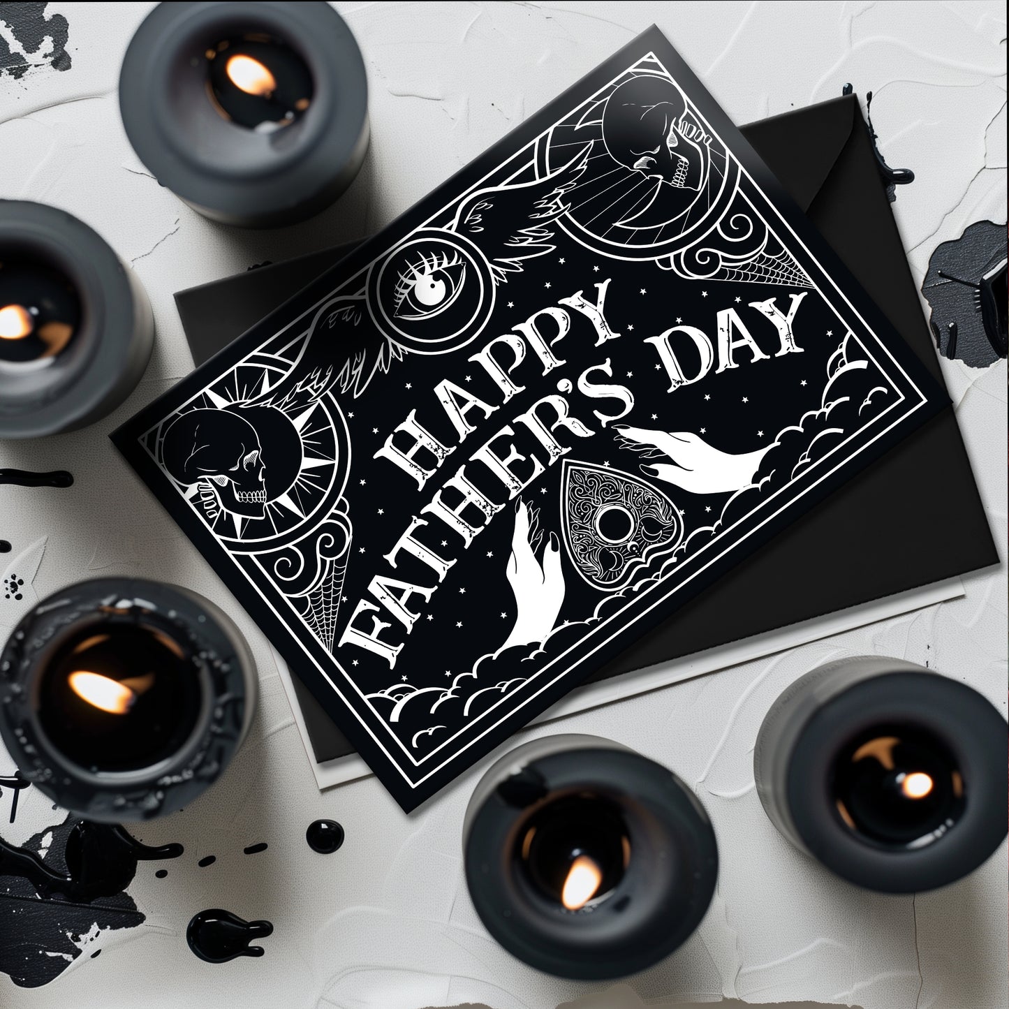 A5 gothic Father’s Day card featuring black and white Ouija board design with ornate “Happy Father’s Day” lettering and planchette detail. Blank inside with envelope. Ideal for witchy, spooky, or alternative dads.
