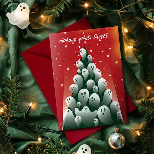A5 glossy portrait Christmas card with red background and starry sky. Green tree flooded with semi-transparent ghosts, white script text “making spirits bright”. Small ghost and stars print inside. Includes red envelope. Blank area for message.