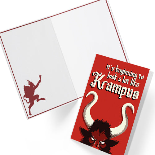 A5 glossy portrait Christmas card on red with large Krampus horns and eyes, cream gothic lettering reading “it’s beginning to look a lot like Krampus”. Small printed Krampus silhouette inside corner. Includes red envelope. Blank area for message.