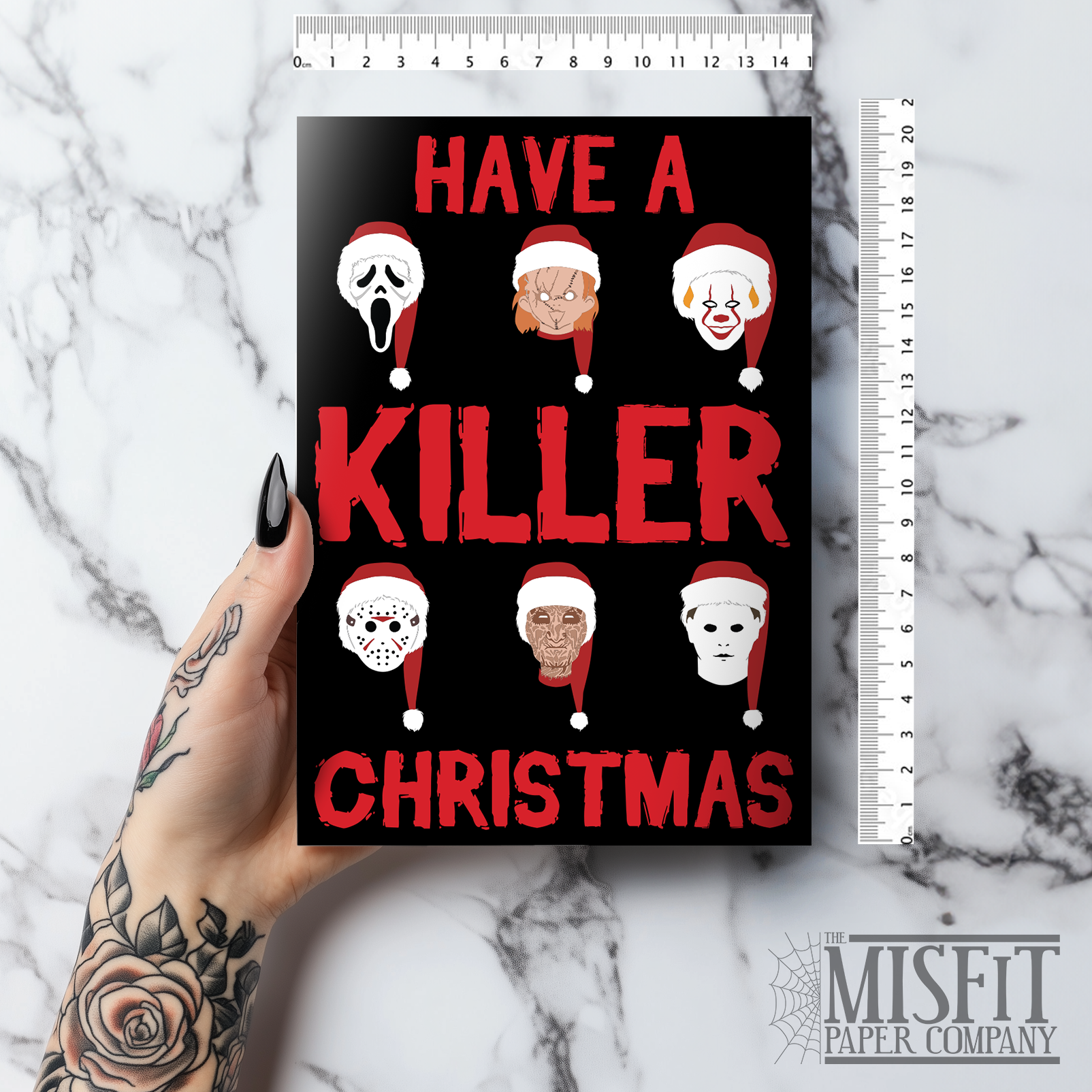 A5 glossy portrait Christmas card on black with bold red text reading “Have a Killer Christmas” and six slasher movie character heads wearing Santa hats. Clean graphic style. Includes red envelope. Blank inside.