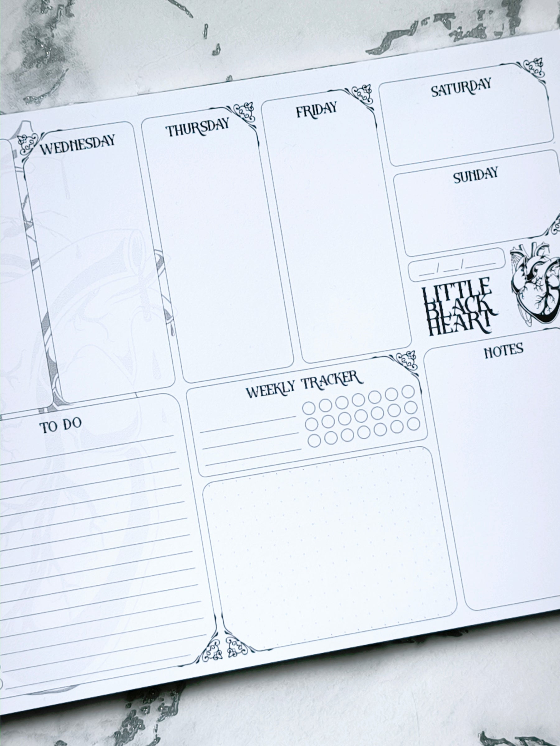 A4 undated weekly planner pad with gothic headings. Large daily boxes, to-do list, notes area, dotted section and habit tracker circles. Monochrome layout on smooth tear-off desk pad.