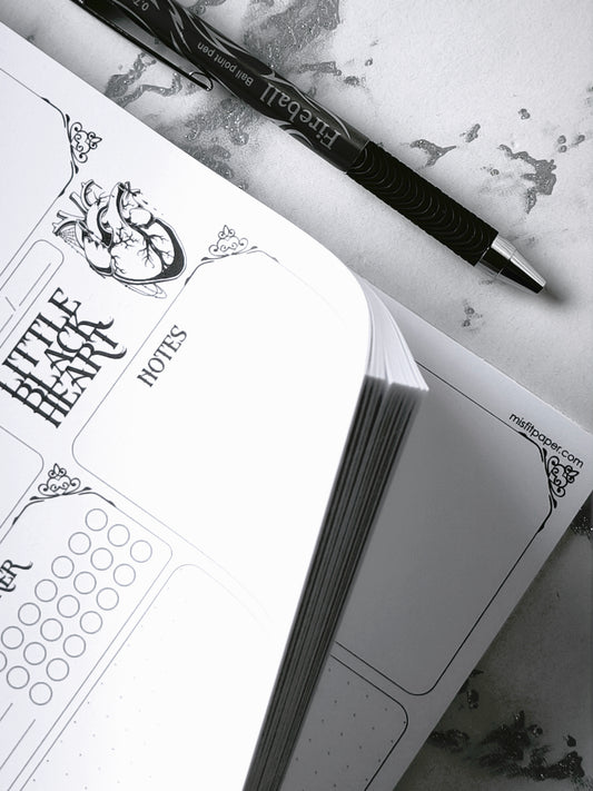 A4 undated weekly planner pad with gothic headings. Large daily boxes, to-do list, notes area, dotted section and habit tracker circles. Monochrome layout on smooth tear-off desk pad.