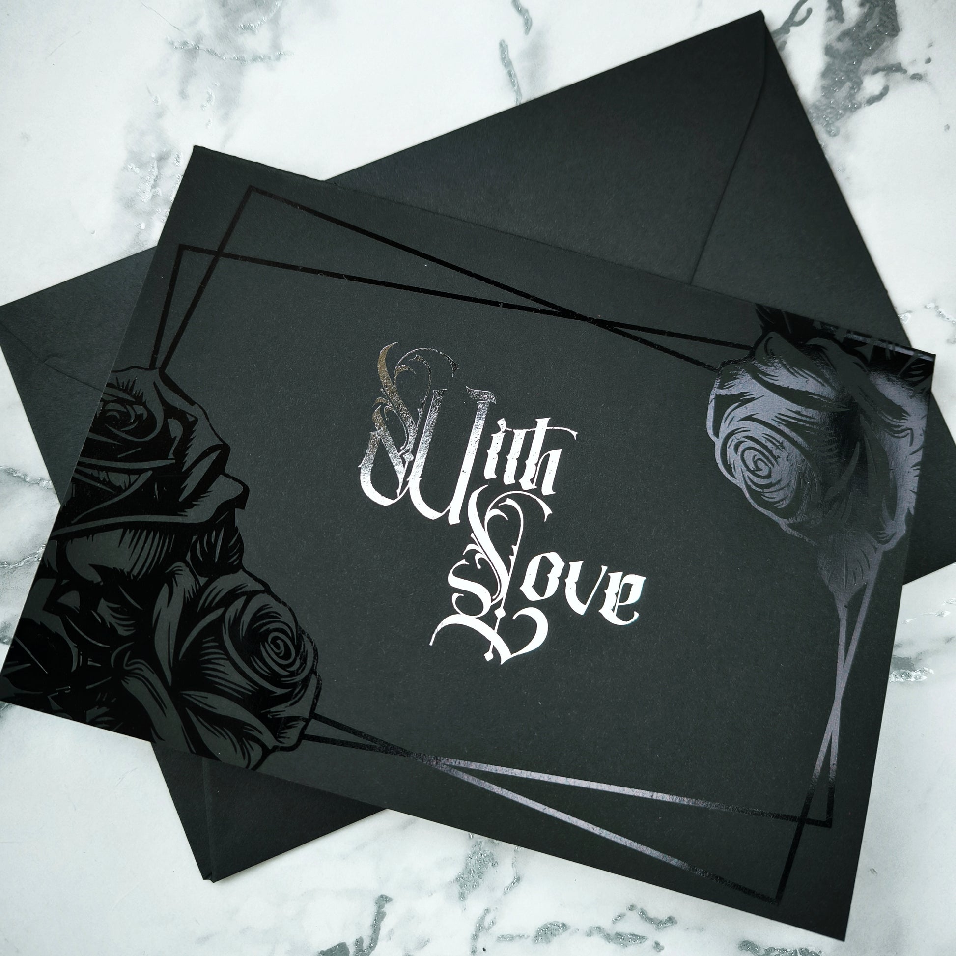 Black Rose Foiled With Love Card features deep black foiled roses and ornate silver foiled Victorian lettering reading “With Love.” 