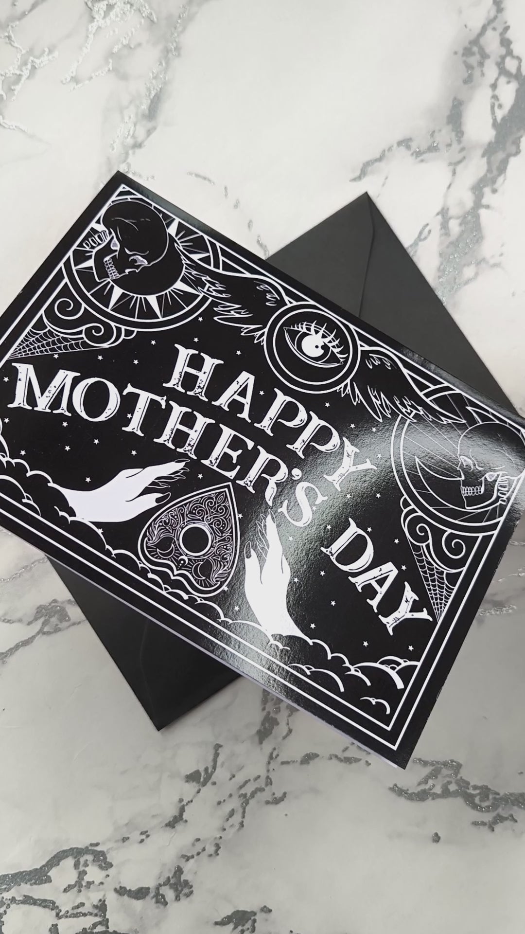 Gothic Mother’s Day card with black and white Ouija board design and ornate planchette details, blank inside with illustrated interior and matching envelope.