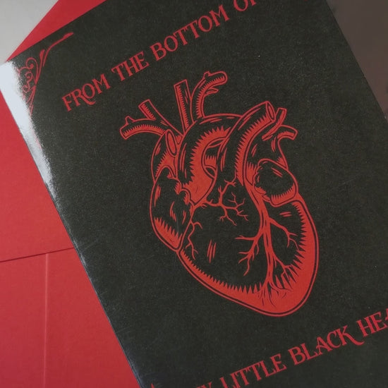Glossy black A5 card with a lifelike red Victorian heart illustration. Text says “From the Bottom of My Little Black Heart.” Includes envelope. Perfect for goth and alternative romance.