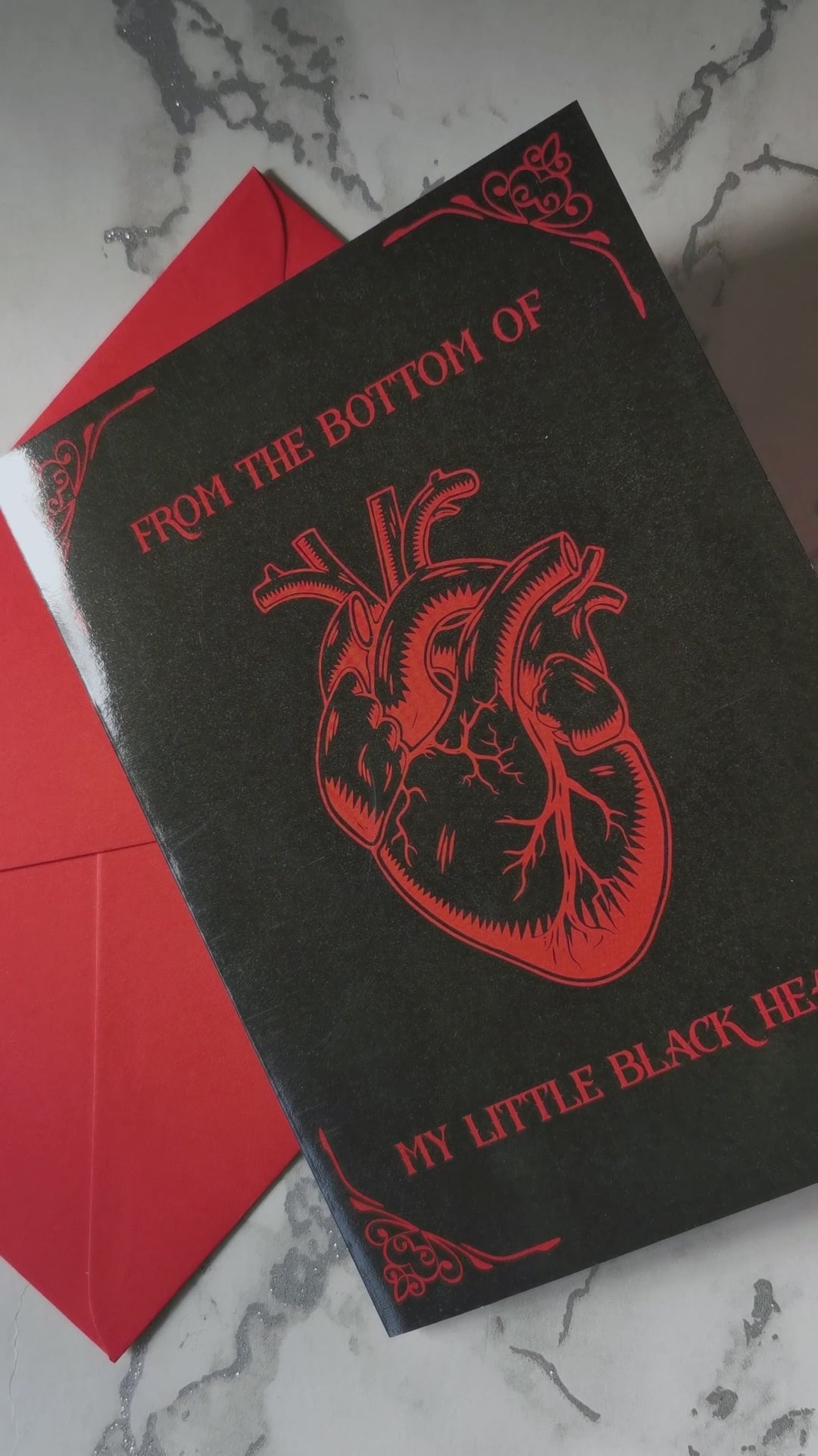 Glossy black A5 card with a lifelike red Victorian heart illustration. Text says “From the Bottom of My Little Black Heart.” Includes envelope. Perfect for goth and alternative romance.