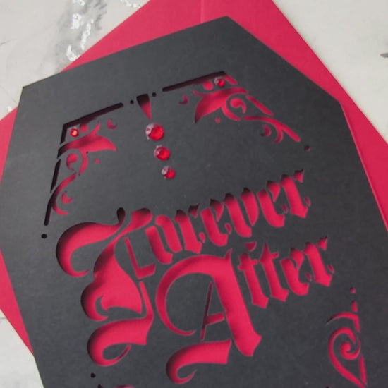 Intricately cut from rich black card with blood-red backing, this dramatic design features a blooming red rose and sparkling red gems for a touch of macabre glamour.